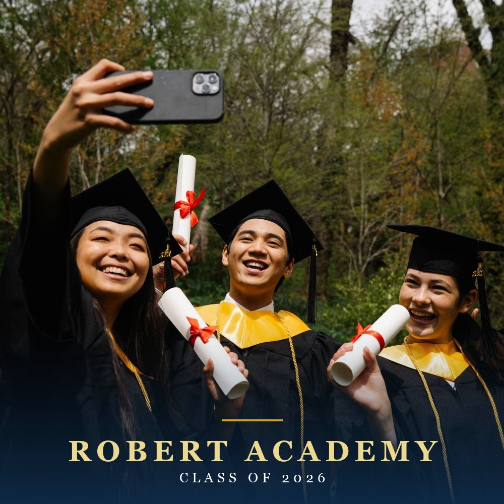Robert Academy graduate celebrating on campus in her graduation cap